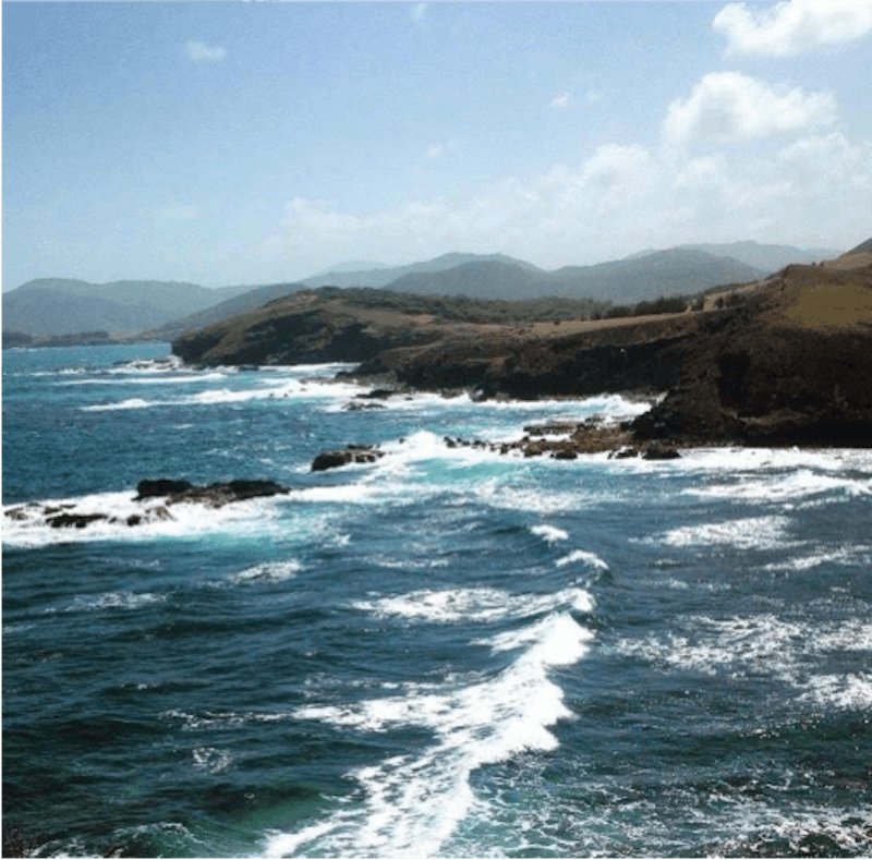 A coastal running retreat with sea waves breaking on the rocks