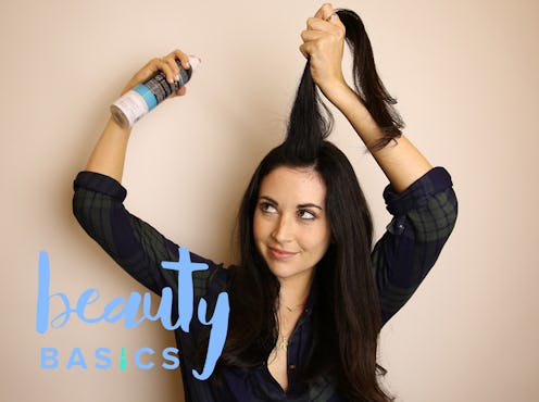 A black-haired girl putting dry shampoo on her hair and a light blue "beauty basics" sign