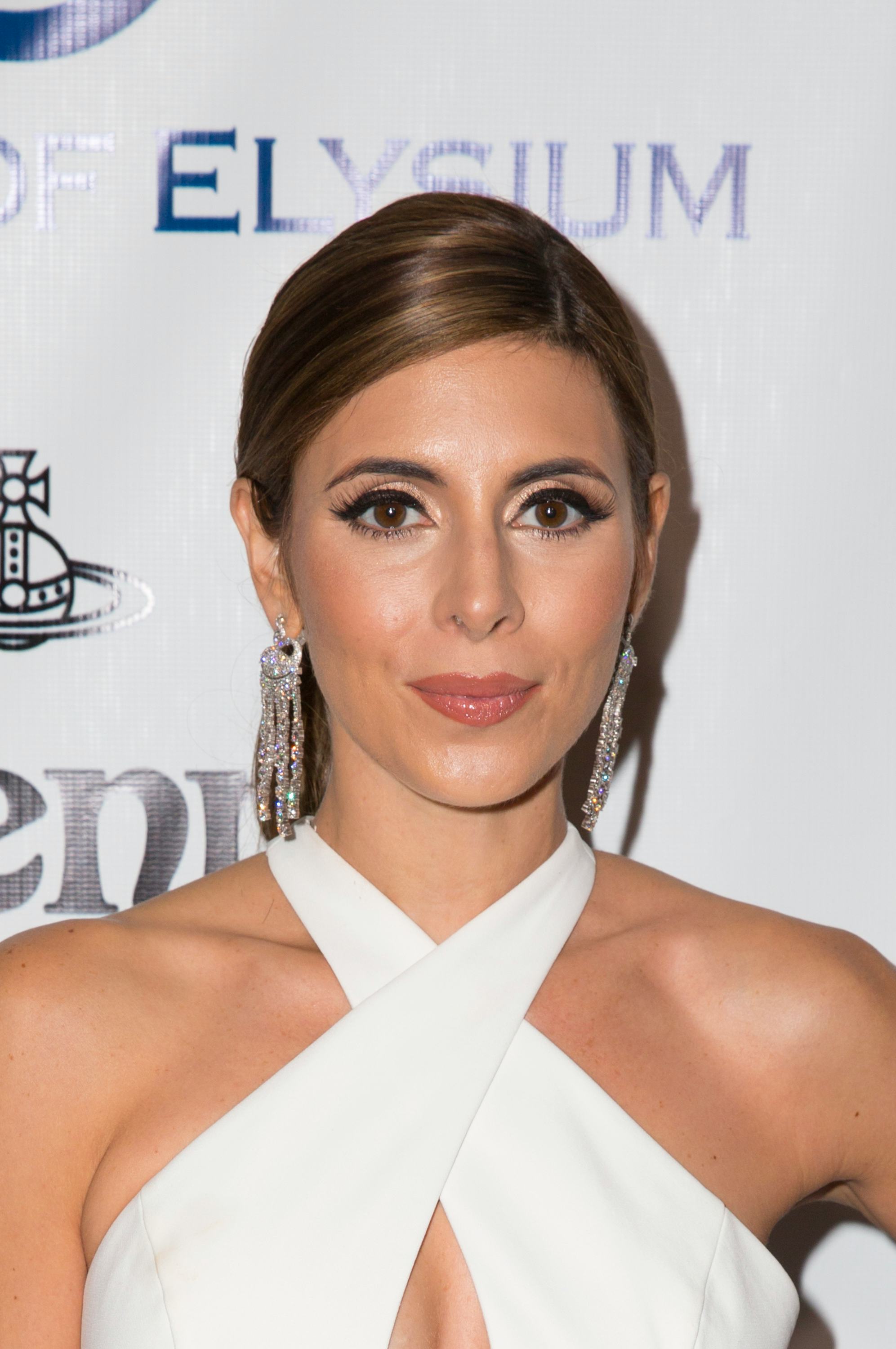 Jamie-Lynn Sigler wearing a white halter dress on a red carpet