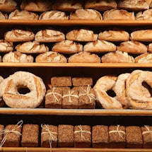 For rows of different types of bread displayed at a bakery