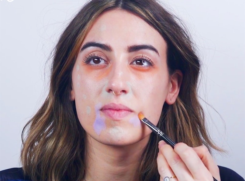 A woman color correcting her face