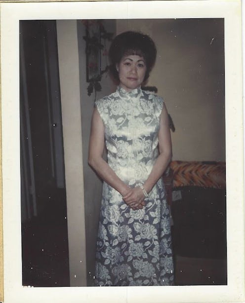 A polaroid picture of a grandma in a silver dress with a white pattern