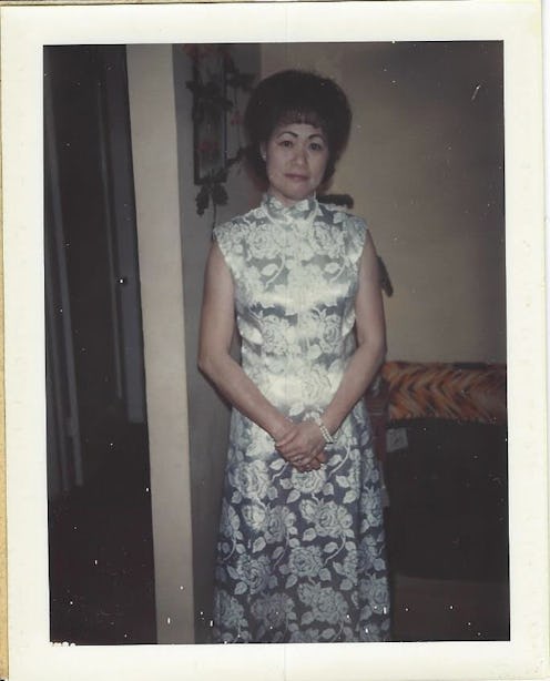A polaroid picture of a grandma in a silver dress with a white pattern 