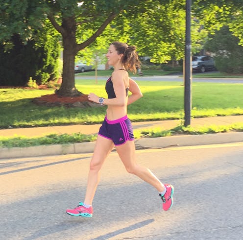 A young woman in her gym clothes running in the park