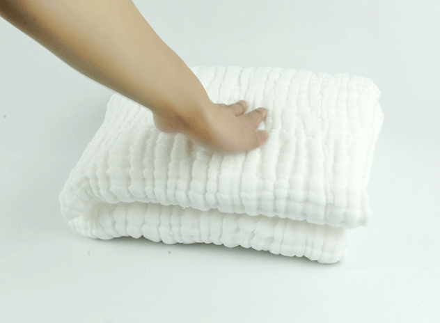 Female hand touching the fresh out of the washing machine towel