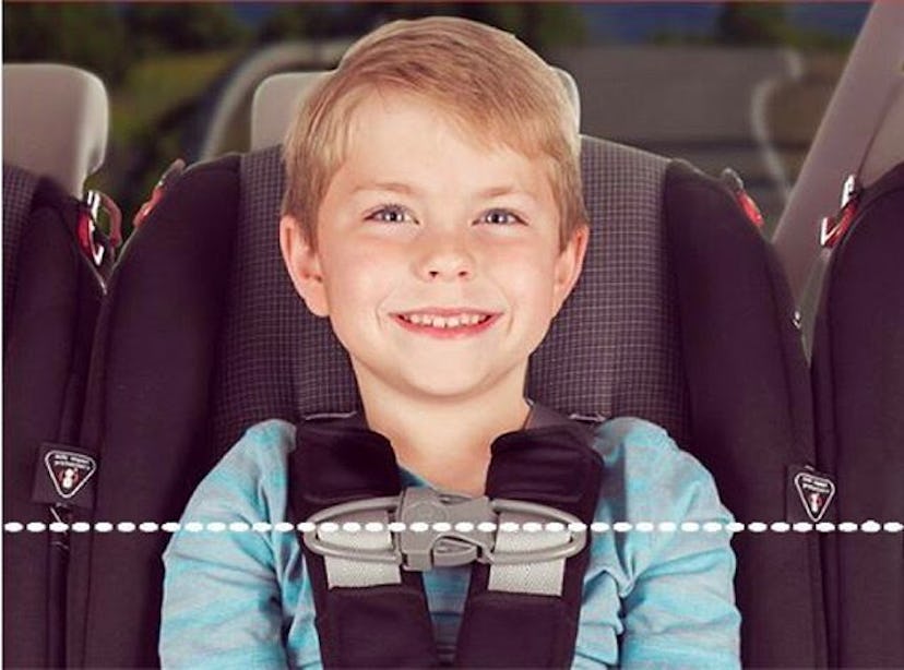 A blonde boy siting in his car seat and smiling