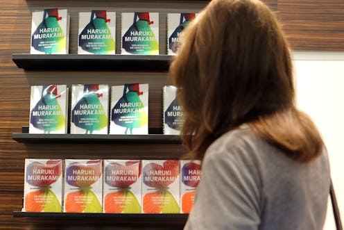 A woman looks at books for sale by Haruki Murakami.