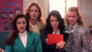 The main cast from the teen movie "Heathers" standing together in a screenshot from the movie