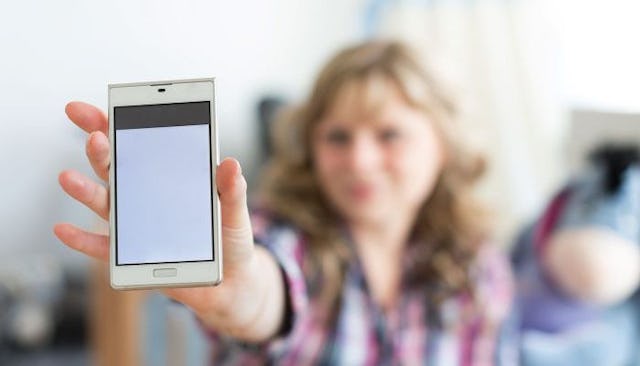 Girl showing a message on her cell phone