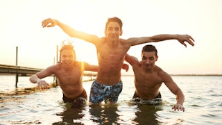 Three teenage boys swimming in the sea 