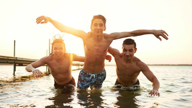 Three teenage boys swimming in the sea