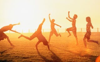 Large group of kids playing on a sunny beach