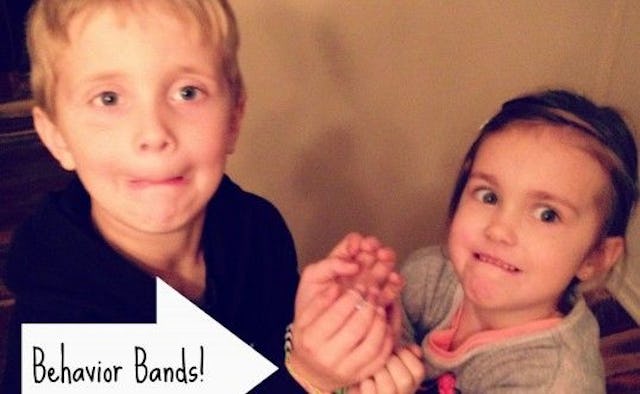 Two children with their hands binded together with a Rainbow Loom rubber band repurposed as Behavior...