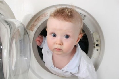 A kid in a white shirt coming out of a washing machine