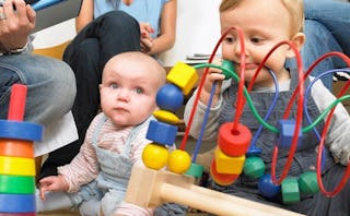 Kids playing with a colorful abacus toy at the doctor's appointment