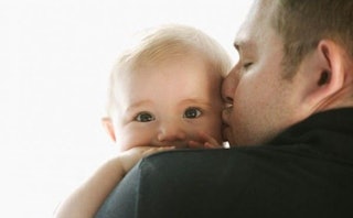 A gay father kissing his baby