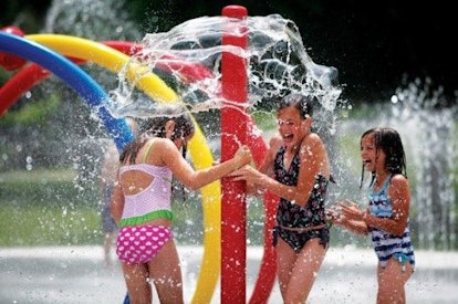 Three girls smiling and playing in Scottsdale Splash Pads