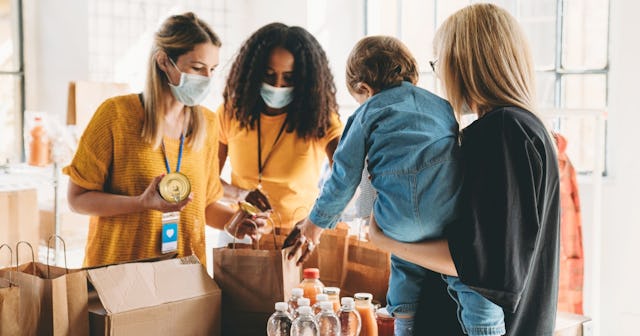 Women collecting items at a food drive — Thanksgiving food drive list.