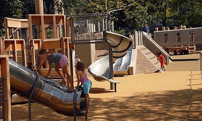 A New York playground with kids playing in it.