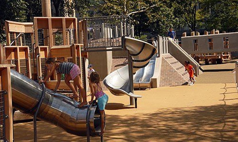 A New York playground with kids playing in it.