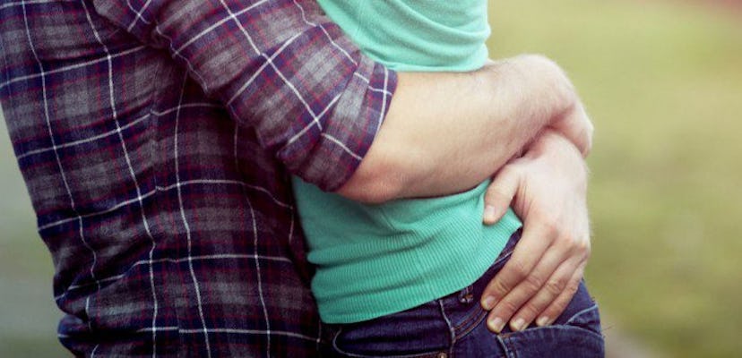 A man and a woman coping with a miscarriage, hugging each other.