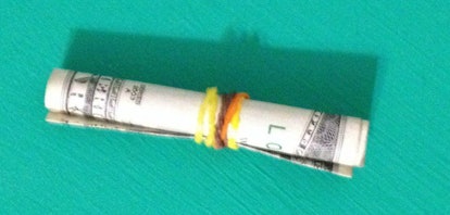 Rainbow Loom rubber bands holding cash together, repurposed as Bundle Bands to hold money.