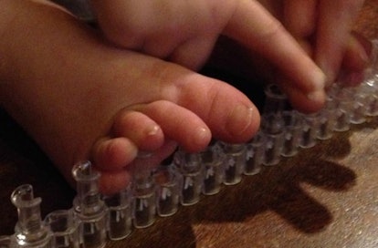 Rainbow Loom rubber bands used to separate toddlers' toes, repurposed as Pedi Partner.