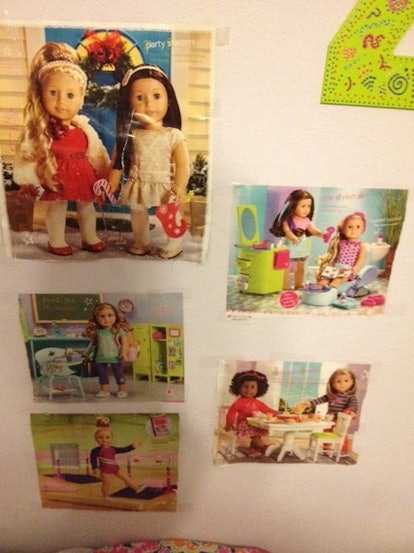Five posters featuring American Girl Dolls on the wall