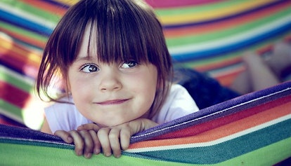 Girl smiling while lying down in a swing