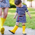 A mom who is not best friends with her daughter, both wearing yellow rain boots