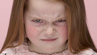 A portrait of a nagging little girl with an angry facial expression