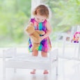 Little Girl Putting A Teddybear To Bed
