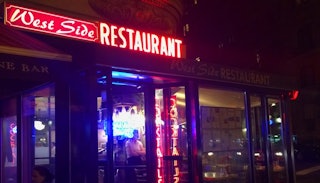 The entrance door of the West Side Restaurant at 69th and Broadway in New York during night time