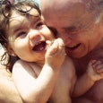 Grandpa and granddaughter having fun on a beach