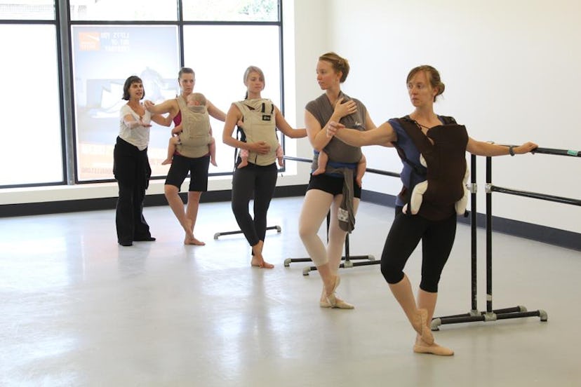 A group of five mothers during a babywearing ballet class holding their babies