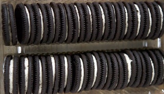 Two rows of Oreo cookies stacked in a box