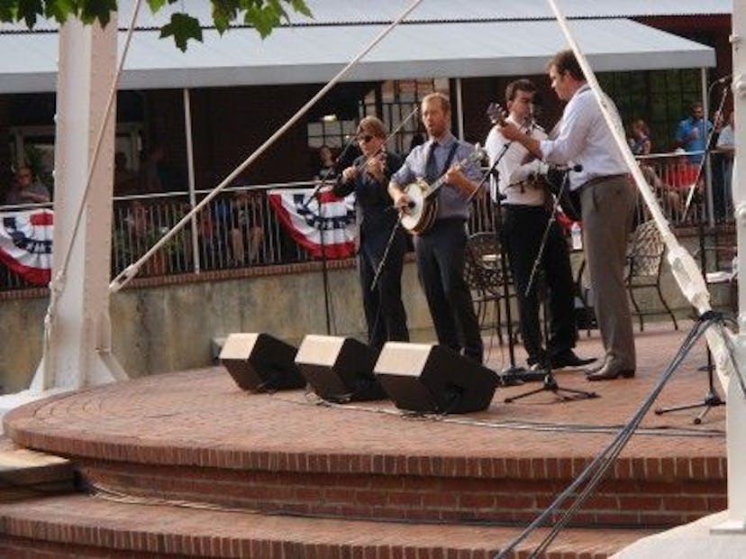 Four men playing their string instruments at Chapel Hill
