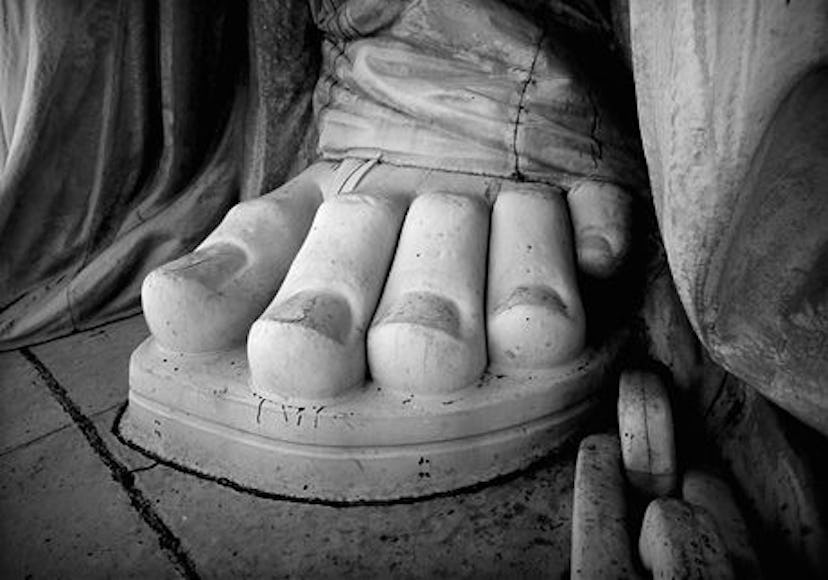 The toes of the Statue of Liberty in black and white