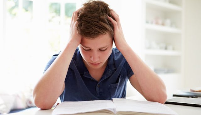 A desperate boy studying