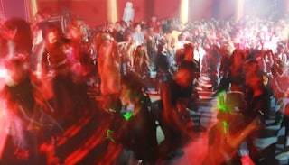 A crowd of young people dancing at a bar