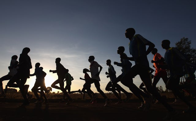 Several people in a group running and making it a habit with the sunrise in the background