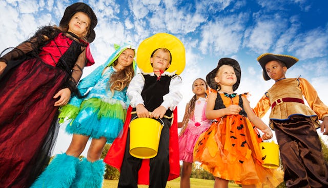 Boys and girls wearing colorful Halloween costumes