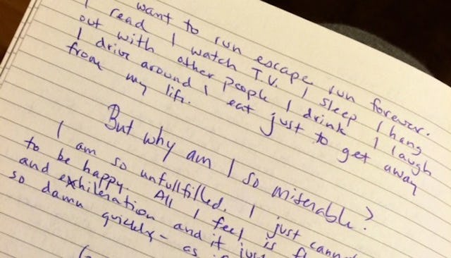 A diary entry into a notebook by a woman writing about her feelings about becoming a new mom