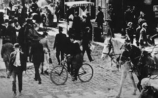 Black and white image of an old square with a lot of people from 126 years ago 