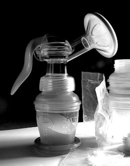 A breast pump and another bottle next to it in black and white
