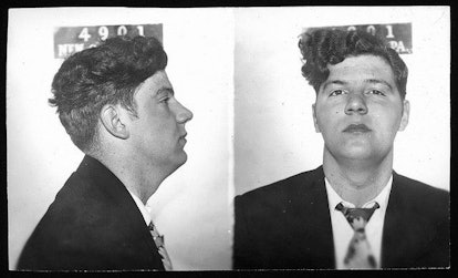 A full-profile jail photo of a young man