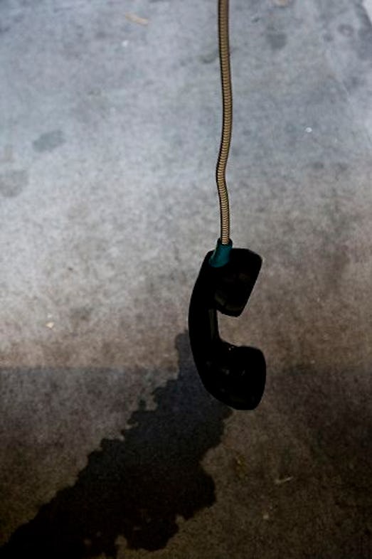 Telephone handset hanging in the air