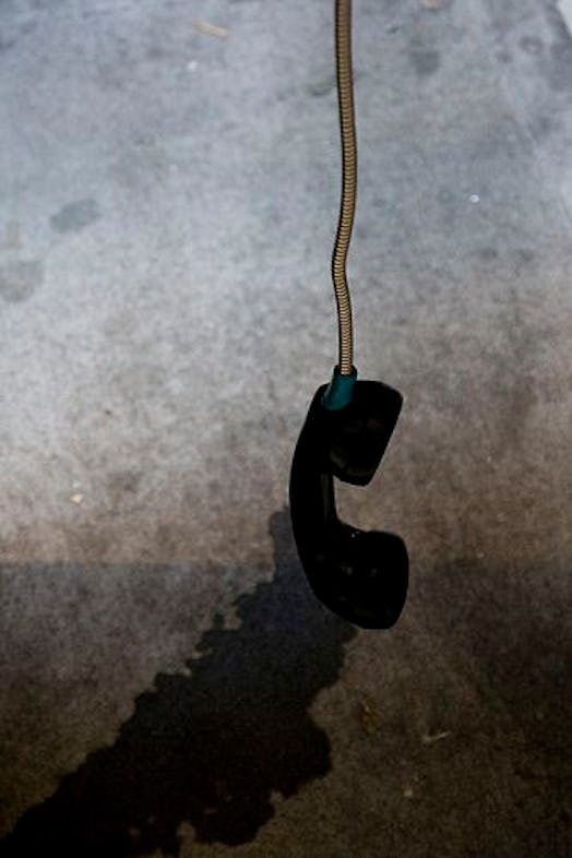 Telephone handset hanging in the air