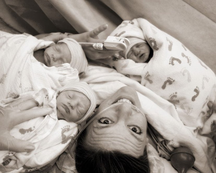 A woman with her newborn triplets