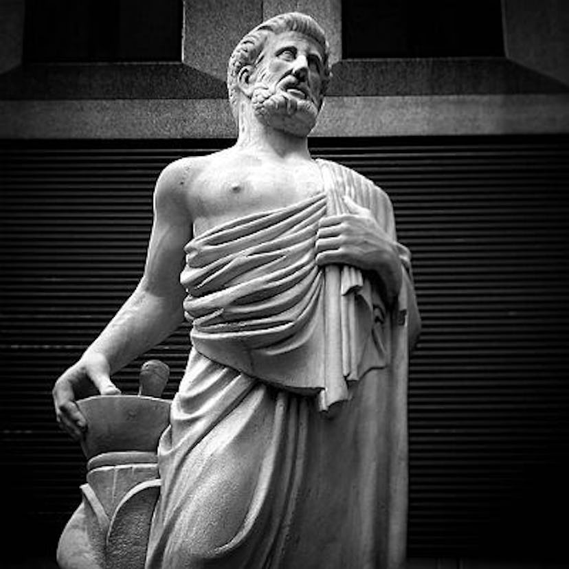 A statue of Hippocrates in black and white